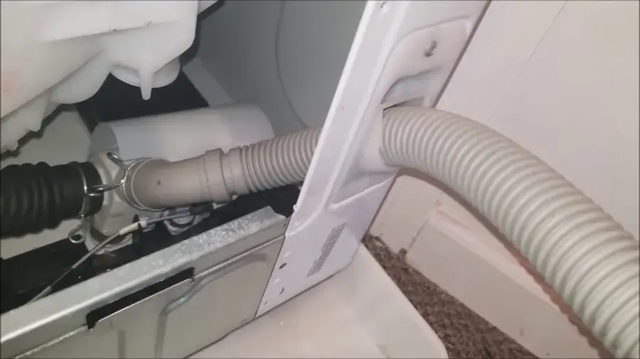 Washing machine drain hose behind the machine in a Wake Forest laundry room