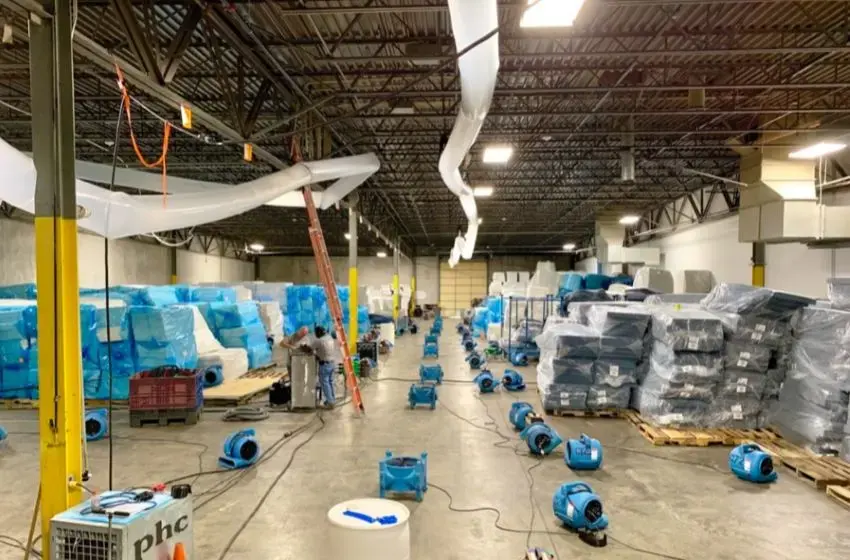 Rows of air movers drying a large commercial floor in the Wake Forest area