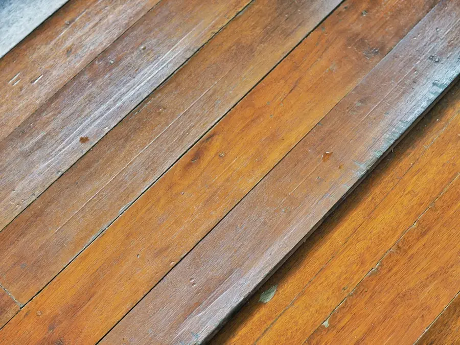 Water-cupped oak floorboards in an older Wake Forest home